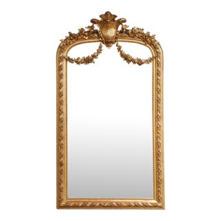 19th Century French Louis XVI Giltwood Mirror With Shield Crest and Floral Decor For Sale