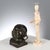 Bronze sculpture depicting the head of a laughing child. Square marble base. Artist: Anonymous. This piece is attributed...