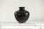 This large vintage ceramic vase features a dramatic charcoal-gray glaze with a smooth finish, emphasizing its graceful,...