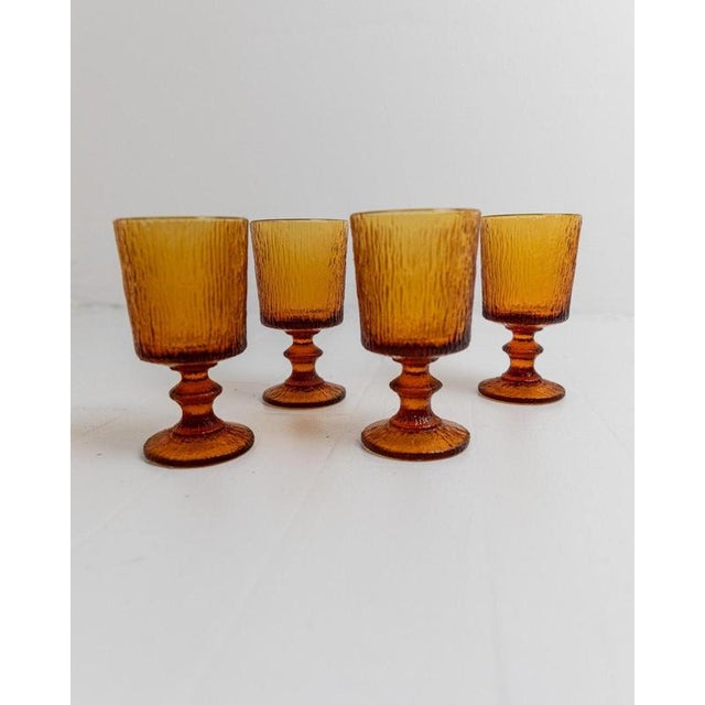 This Vintage set of 4 wine glasses from the 1970s is a refined design by Timo Sarpaneva for Iittala, showcasing the...