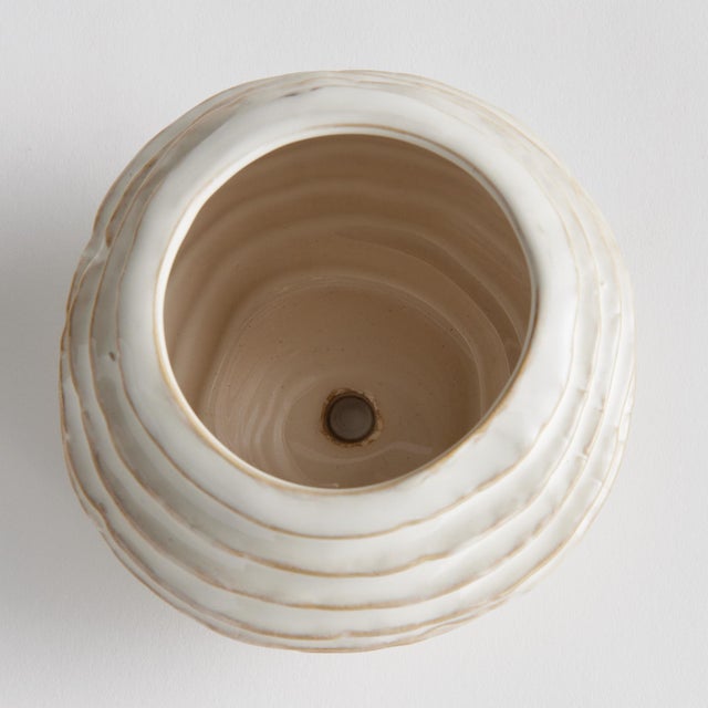 With a reactive glaze and hand finished ribbing detail, this charming sage green pot is a great find. Plant your favorite...