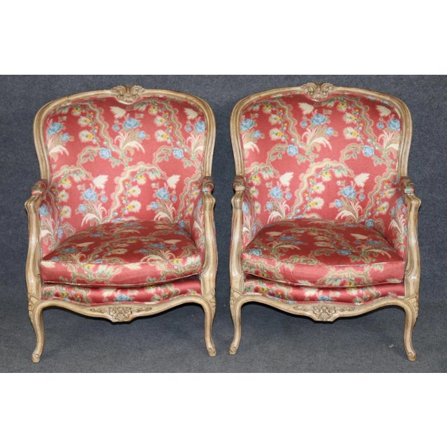 This exquisite pair of French Louis XV bergère armchairs beautifully captures the refinement and romance of 18th-century...