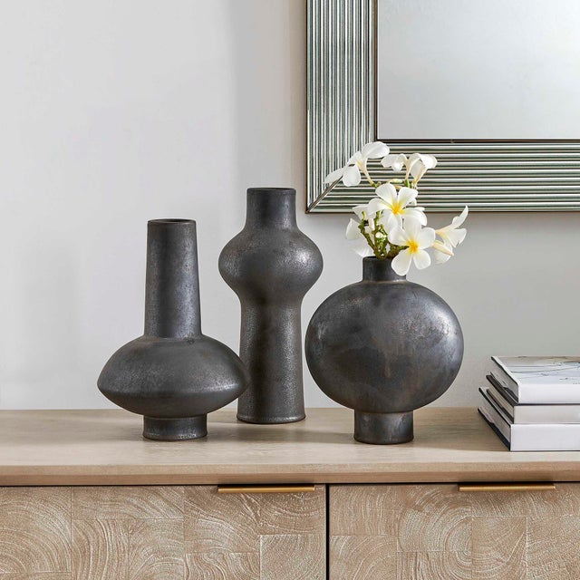This Striking Trio Of Ceramic Vases Features A Distressed Black Finish With Subtle Dark Bronze Undertones, Giving Each...