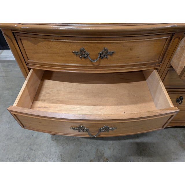 Vintage Dixie Furniture Company French Provincial dresser featuring a warm wood-tone finish. This statement piece has a...