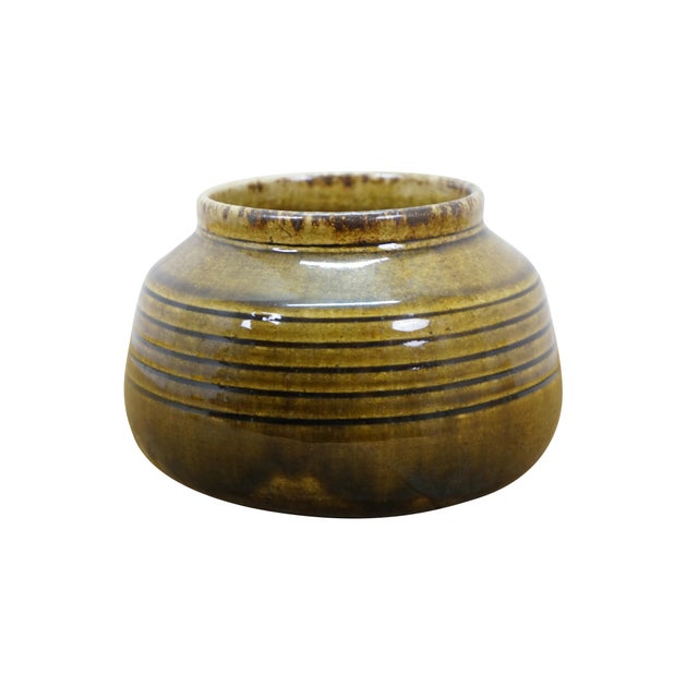 Vintage studio pottery vase or bowl by Thai Celadon. It features a ribbed texture with a brown / green / olive glaze....