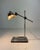 Elegant art deco desk lamp crafted in chrome-plated metal; it features a weighted rectangular base, a fixed vertical...