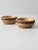 This is pair of vintage wooden bowls. The decorative bowls feature hand-tooled pyrography in a geometric pattern.