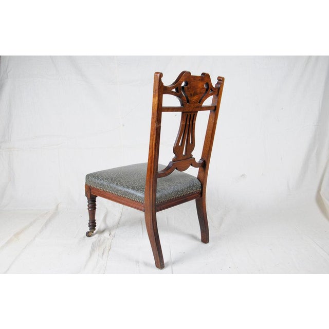 This 19th Century Slipper Chair has an embossed Edelman Leather seat finished with decorative brass upholstery tacks, and...