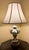 A charming pair of vintage porcelain table lamps featuring richly detailed hand-applied floral decoration, reticulated...
