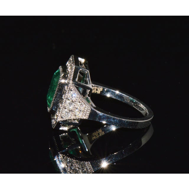 GIA certified 3.98CTS diamond and emerald solid 18K white gold ring. This elegant cocktail ring features a GIA certified...