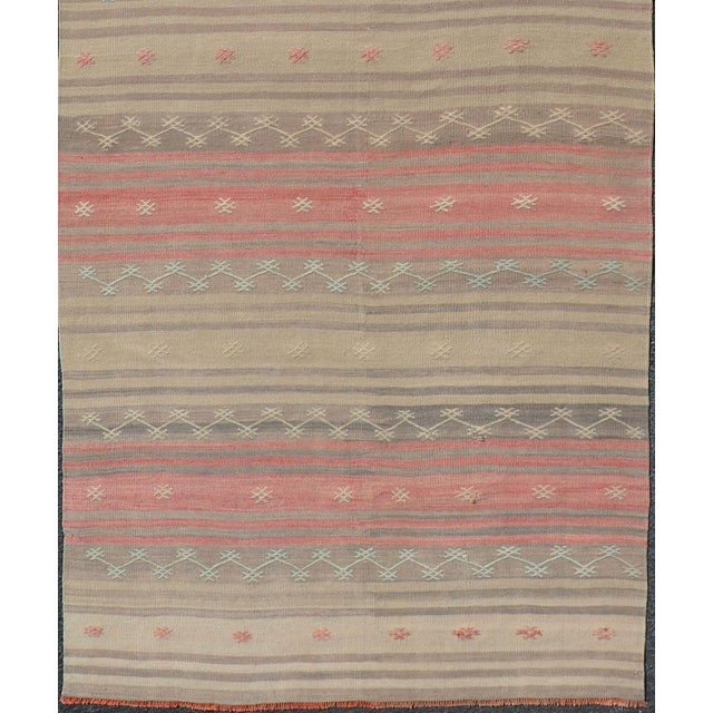 Multicolored vintage Turkish Kilim rug with horizontal stripes in tan, blue, brown and orange. Keivan Woven Arts / Vintage...