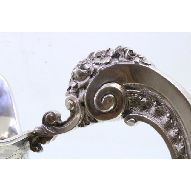 Shell-Shaped Silver Water Jug in the style of D João V, in Very Good conditions. Designed 1920 to 1949 This piece has an...