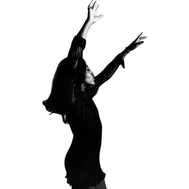 25th November 1969: Studio portrait of rock singer Tina Turner, wearing a dark crocheted mini-dress, dancing in profile...