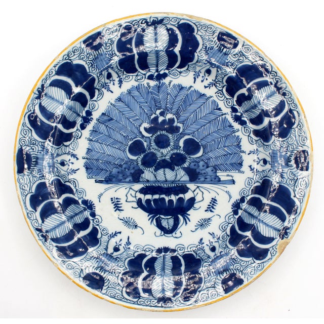 Circa 1780 pair of Delft blue & white large chop plates or chargers. Centered on reserves of peacock feathers made by &...