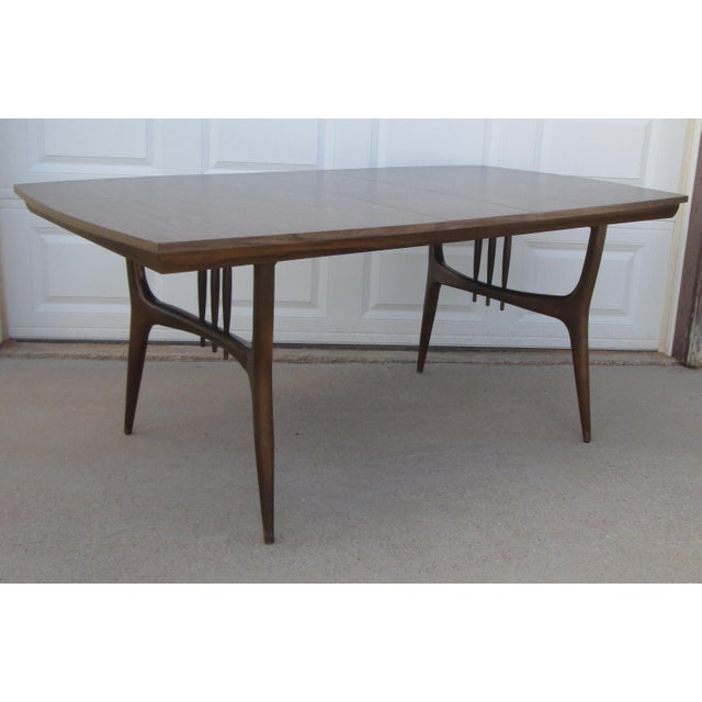 Mid century modern / Danish Modern walnut dining table by the Holman Manufacturing Co. of Pittsburg, Texas. The table has...