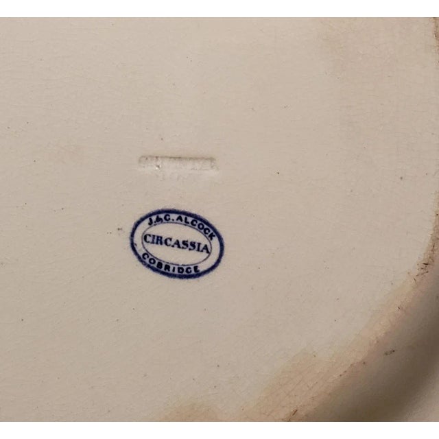 Early 1800's Flow Blue "Circassia" Platter by J. & G. Alcock. The platter features a water scene with oriental buildings,...
