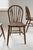 Set of four late 19th-century English hoop-back Windsor chairs with solid elm seats, each showing a rich, hand-worn patina...