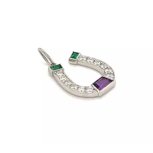 This authentic charm is from Tiffany & Co. It is crafted from platinum featuring a charming horseshoe set with sparkling...