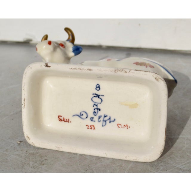 Royal Delft (De Porceleyne Fles) cow figurine. Model #253 and signed by the painter C M. Imari style Dutch porcelain with...