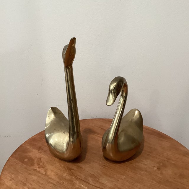 Elevate your decor with this stunning pair of mid-century modern brass swans, a graceful addition to any room. The larger...