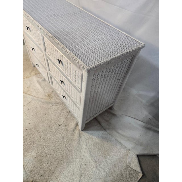 Vintage coastal style six drawer dresser finished in white wicker/rattan wrap with braided trim detailing and metal ring...