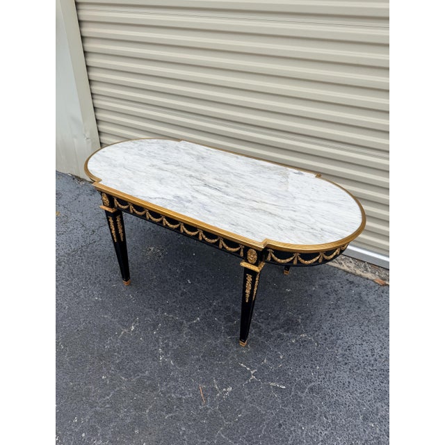 Designer couch table in Louis XVI black, white marble Solid beechwood painted black and with gilded bronze. Slightly...