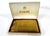 A gold toned cigarette case with lighter to the top and two internal areas inside for whatever you smoke. Manufactured by...