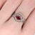 A Mozambique ruby glows in a vivid red at the centre of this solid 14K white gold ring, set east-west and encircled by...