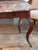 A French mahogany table fitted with a rectangular marble top resting above a single drawer set into the apron. The drawer...