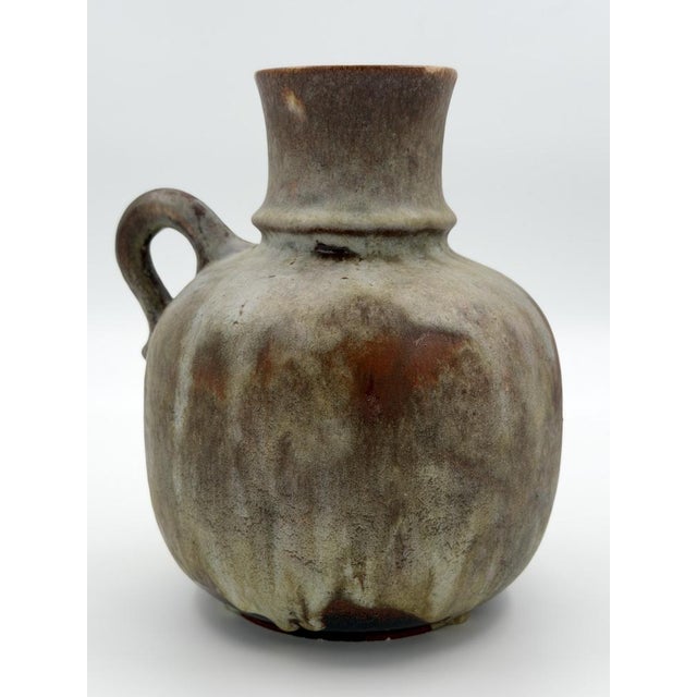 A beautiful example of West German Mid-Century ceramic design by Ruscha Keramik. This sculptural vase features the iconic...