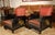 Black lacquer salon chairs with chinoiserie hand painted floral motifs on arms. One chair decorated with lotus blossoms...