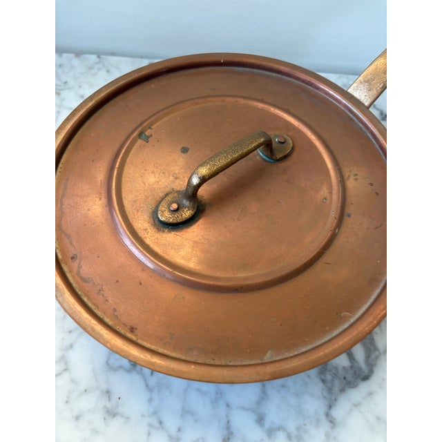 Quintessential to the pot of France, this lovely antique copper pot will bring rustic French charm to any kitchen.