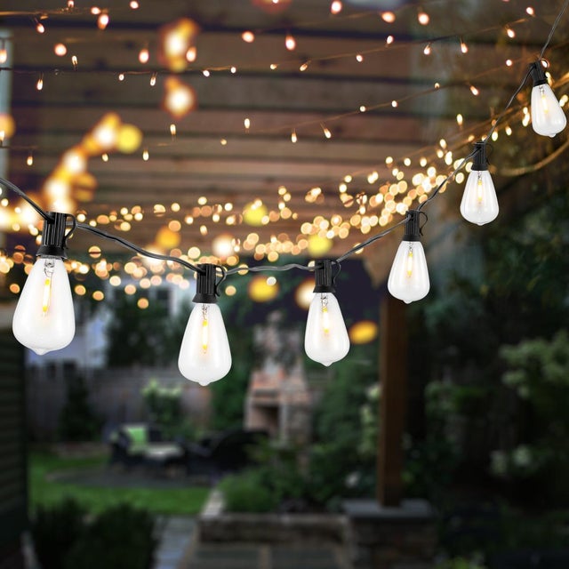 Illuminate your outdoor space with the Dorcia 10 light black string light, a sleek addition to any backyard, patio, or...