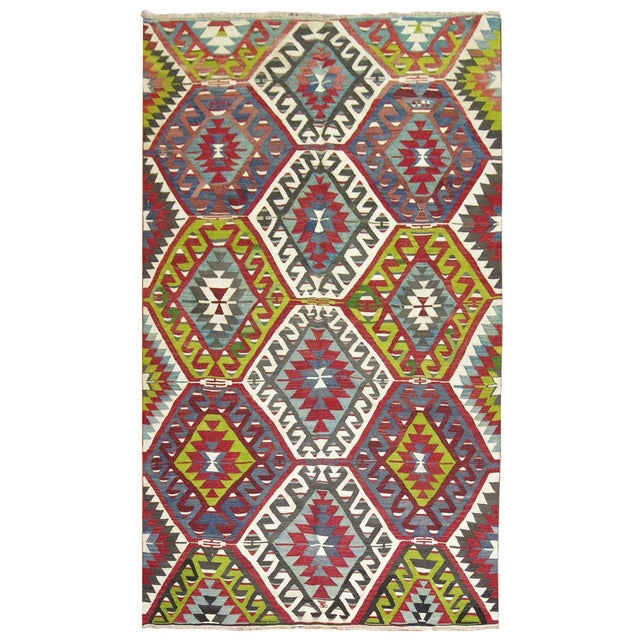 Vibrant colored geometric Turkish Kilim from the mid-20th century. Measures: 5'2” x 9'10”.