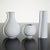 This set of five model Surrea stoneware vases with white glaze was designed by Wilhelm Kåge and produced by Gustavsberg...