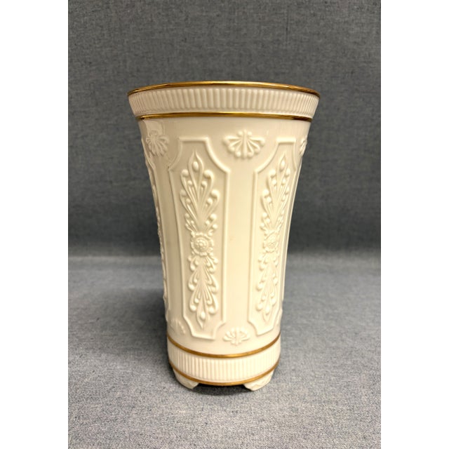 A vintage Lenox footed vase with 24 karat gold trim. The tall ivory vase is part of the Versailles collection and was made...