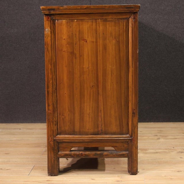 Chinese sideboard from the second half of the 20th century. Wooden cabinet with four doors and two drawers of excellent...