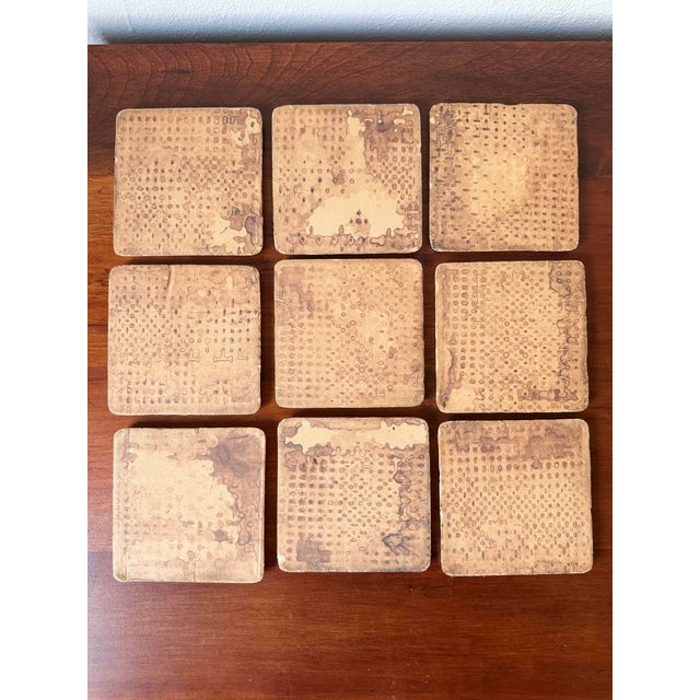 Charming set of nine hand-painted ceramic tiles featuring whimsical village and countryside scenes in a Besheer-style folk...