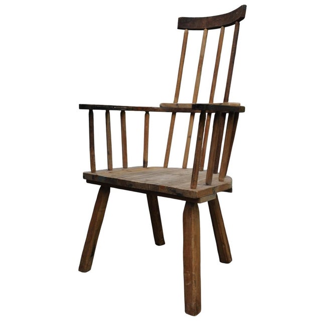 This chair features a vernacular, primitive style, often constructed from local woods. Traditionally made using an elm...