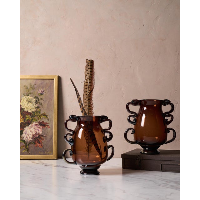 This “Venetian Vase” by CASA is a handblown amber glass decorative vase inspired by traditional Venetian glassware and...