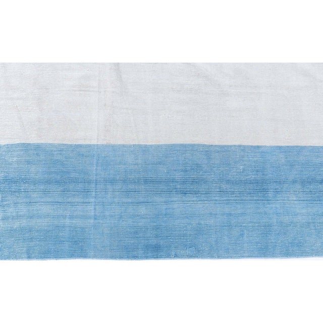 This vintage 1950s Indian Dhurrie rug exemplifies the quiet sophistication and functional elegance that define mid-century...
