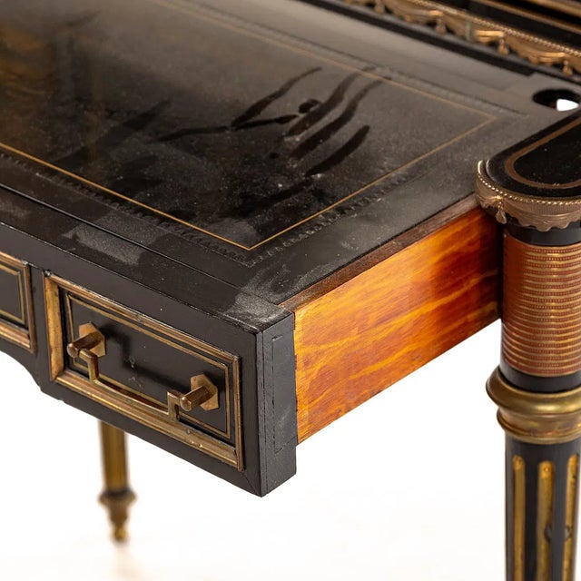 Maison Jansen ebonized writing desk of French origin from the mid-20th century. The composition features a central mirror...