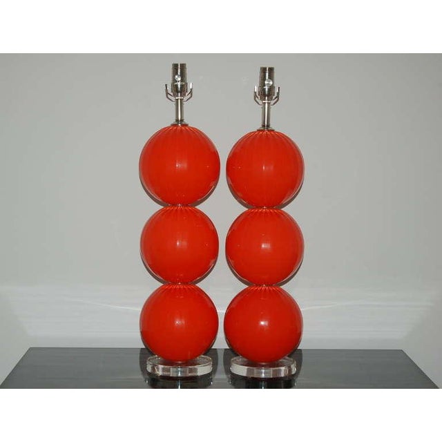 Matched pair of hand blown three ball glass table lamps by Joe Cariati in VERMILLION. Vertical ribs add optical and...