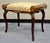 Antique turn of the century French bench. Crafted in mahogany with brass ormolu decoration. Features rolled cylindrical...
