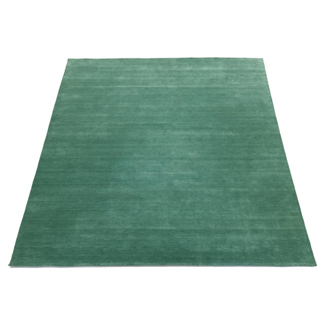 Discover our stunning handcrafted Gabbeh-style wool rug, showcasing a rich Jewel-Toned Green design. Proudly part of our...