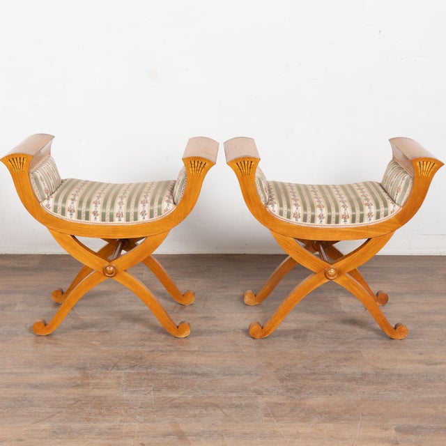This romantic pair of Neoclassical style elm wood Curule stools are from Denmark. Noted style elements include out-...
