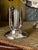 This early 20th-century silver-plated caddy was engineered to hold round-bottom 'torpedo' soda bottles upright during...