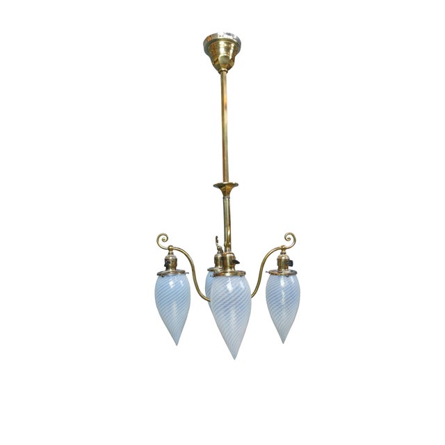 Antique Victorian Hubbell four light pendant chandelier. Made of brass featuring four opalescent / opane swirled glass...