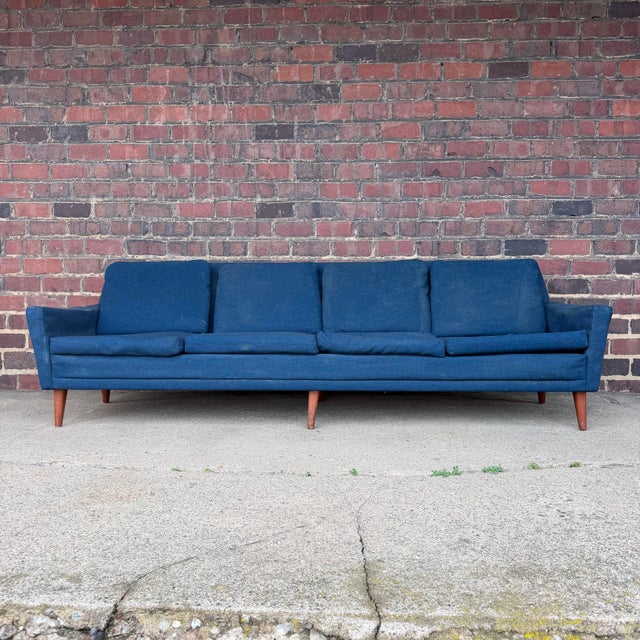 Folke Ohlsson for Dux four seat deep blue sofa with a walnut frame. Will need reupholstered.