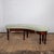 A pair of English canted benches of stained pine with sage green velvet cushions - each bench featuring a canted moulded...